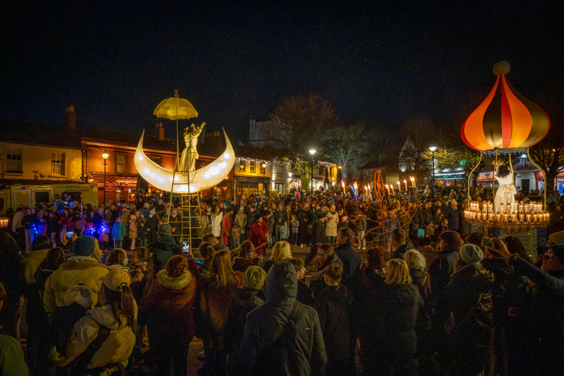 The festival crowd gathered around illuminated lanterns